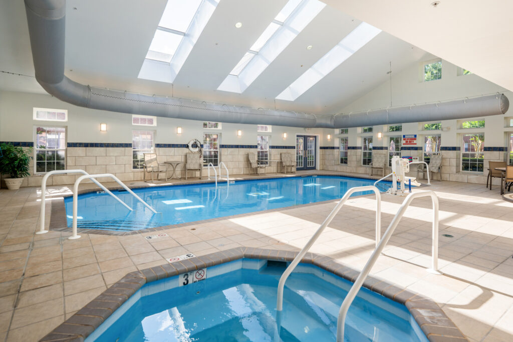 Indoor swimming pool and hot tub at Town Village Audubon Park, a luxurious senior living option.